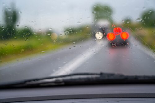 Car driving in the rain with drops on windshield. High quality photo